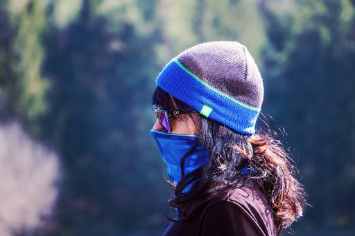  A women wearing a blue face mask